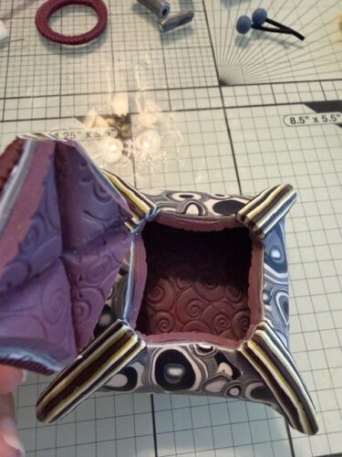 Puff box opened to show its textured interior, by Linda Hess